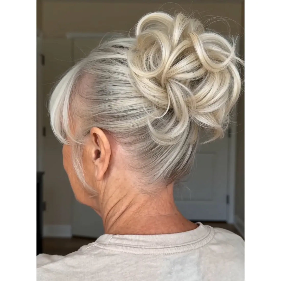white platinum Blonde hair bun on a light gray background