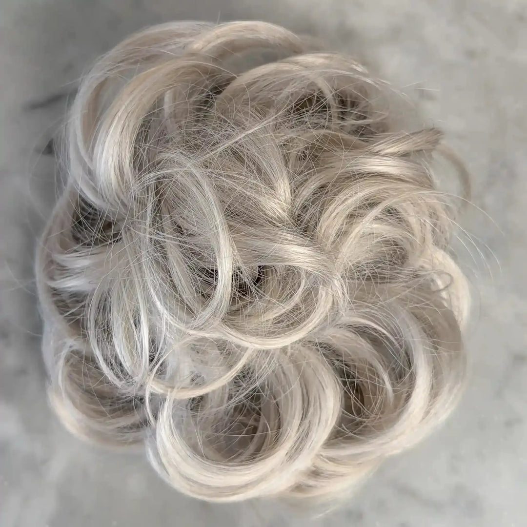 white Blonde hair bun on a gray background